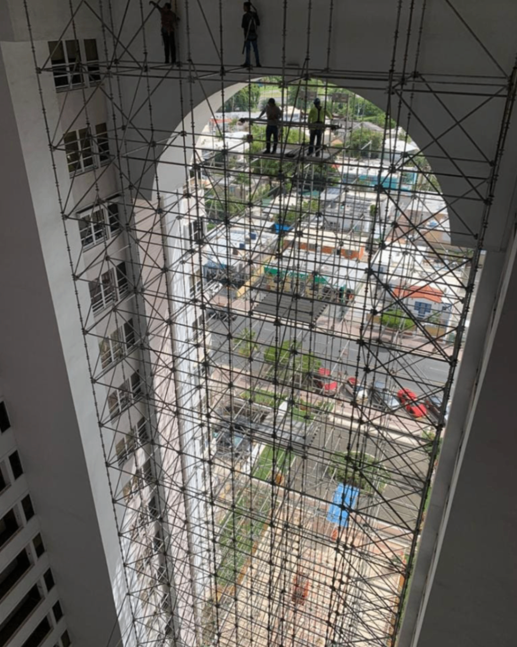 High-rise atrium scaffolding installation with suspended work levels