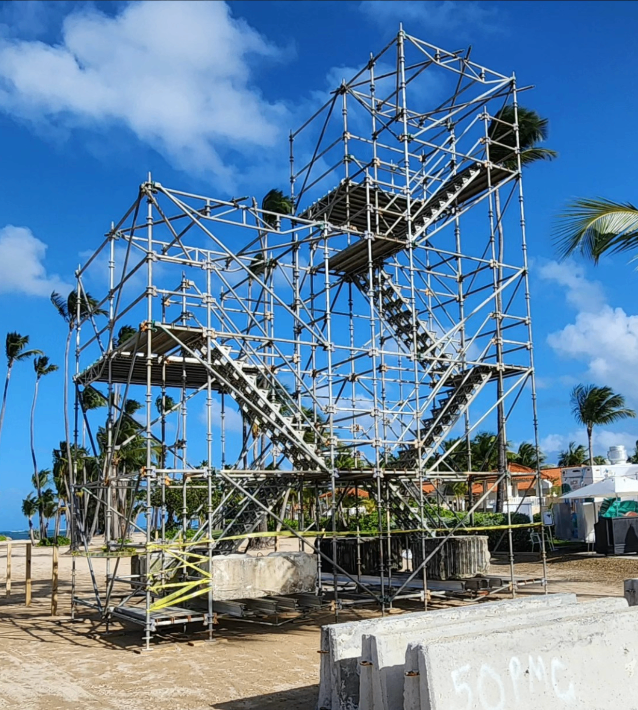 Beachside scaffold tower with stairs and palm trees