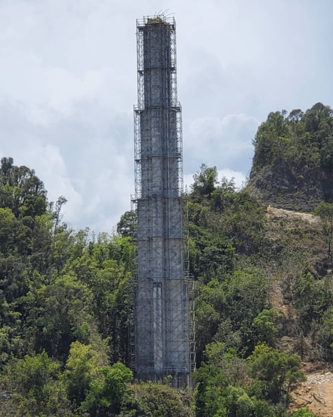 Tall scaffold tower installation in a mountainous outdoor site